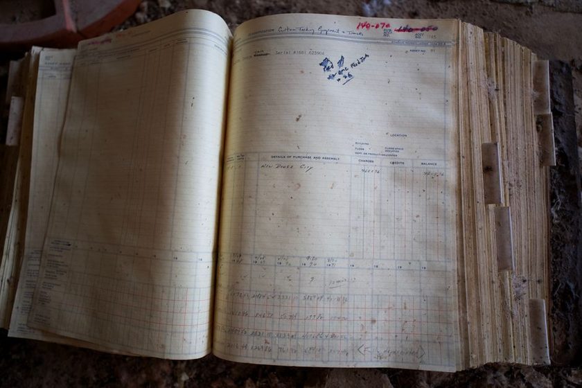 A closed ledger book from a previous year being reopened on a table